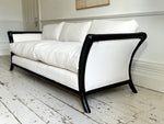 A Napoleon III Large Three Seater Ebonised Sabre Legged Sofa