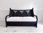 A 1950's French Black Rattan Sculptural Sofa with Piqué Upholstery