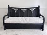 A 1950's French Black Rattan Sculptural Sofa with Piqué Upholstery