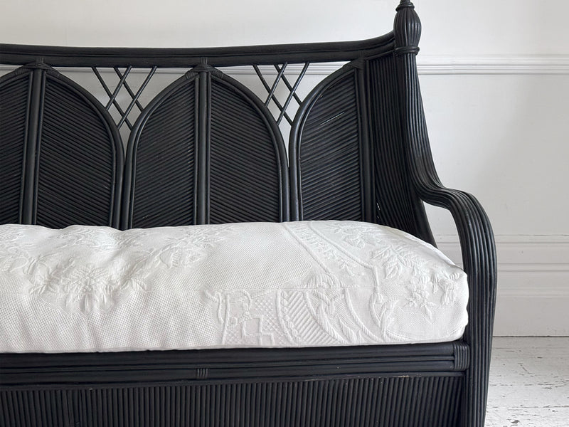A 1950's French Black Rattan Sculptural Sofa with Piqué Upholstery