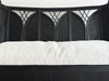 A 1950's French Black Rattan Sculptural Sofa with Piqué Upholstery