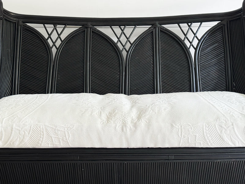 A 1950's French Black Rattan Sculptural Sofa with Piqué Upholstery