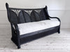 A 1950's French Black Rattan Sculptural Sofa with Piqué Upholstery