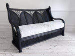 A 1950's French Black Rattan Sculptural Sofa with Piqué Upholstery