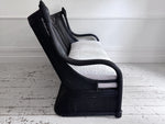 A 1950's French Black Rattan Sculptural Sofa with Piqué Upholstery
