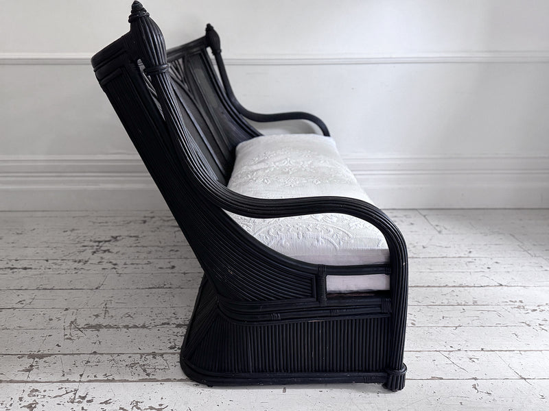 A 1950's French Black Rattan Sculptural Sofa with Piqué Upholstery