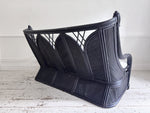 A 1950's French Black Rattan Sculptural Sofa with Piqué Upholstery