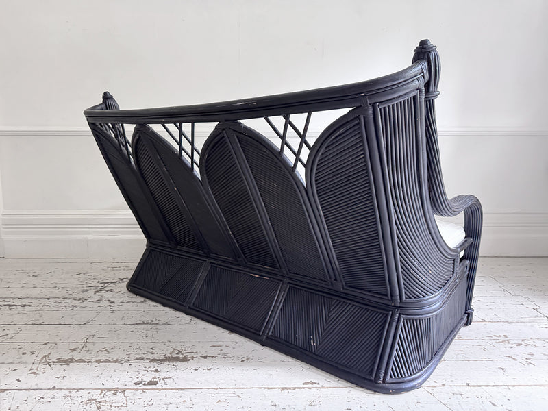 A 1950's French Black Rattan Sculptural Sofa with Piqué Upholstery