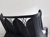 A 1950's French Black Rattan Sculptural Sofa with Piqué Upholstery