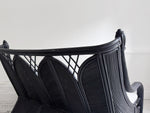 A 1950's French Black Rattan Sculptural Sofa with Piqué Upholstery