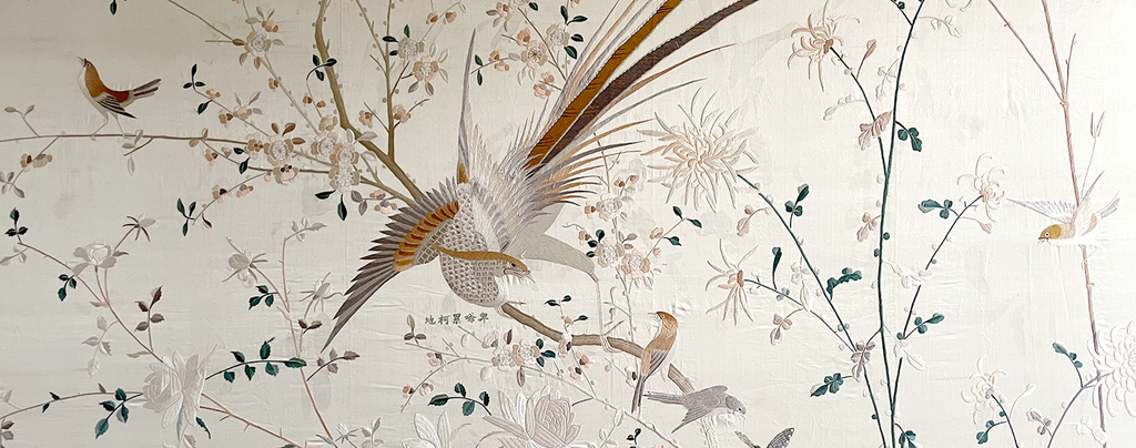 A very large 19th framed Chinese silk on silk embroidery depicting a large central bird and surrounded by smaller birds, flowers and foliage.  Beautifully embroidered and signed.