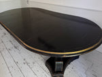 A 1920's Regency Style Ebonised Extending Dining Table