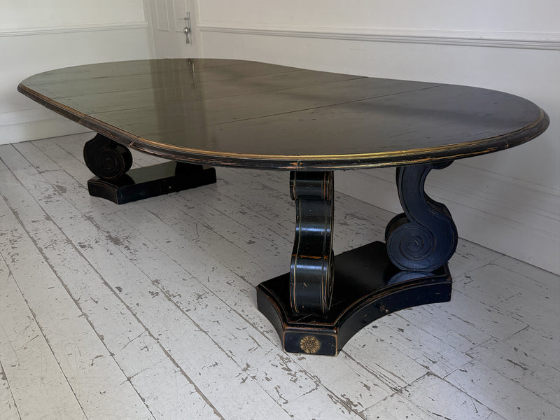 A 1920's Regency Style Ebonised Extending Dining Table