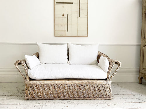 A 1950's French Rattan Sofa with White Linen Upholstery