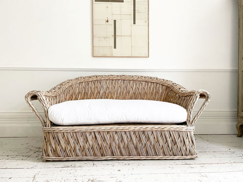 A 1950's French Rattan Sofa with White Linen Upholstery