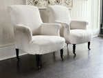 A Pair of Napoleon III Scroll Back Linen Covered Armchairs