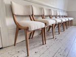 A Set of Eight 1960's Dining Chairs with Bouclé Upholstery