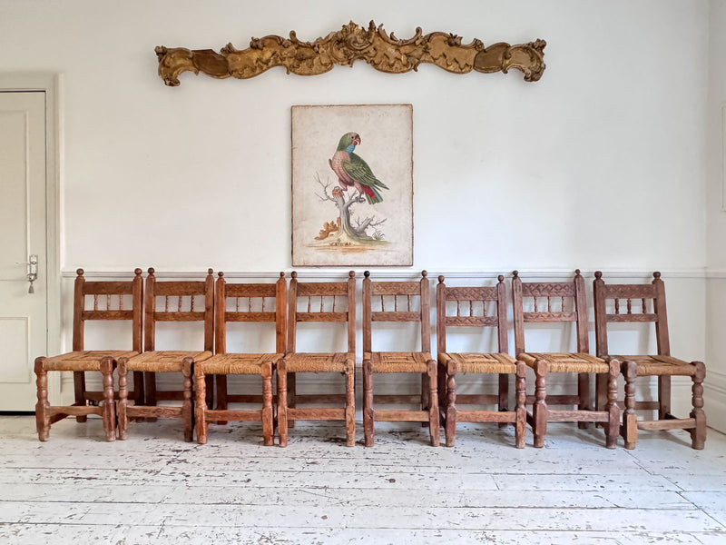 A Set of 8 Antique Spanish Folk Art Dining Chairs with Woven Seats