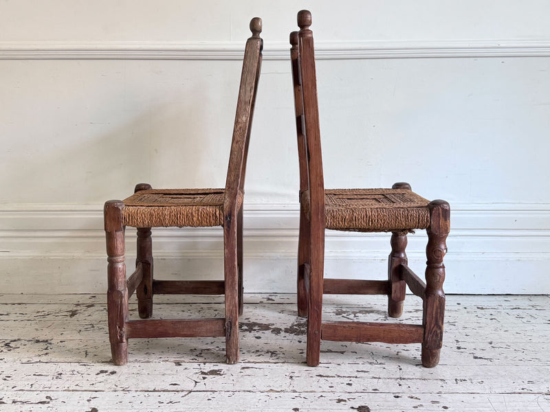 A Set of 8 Antique Spanish Folk Art Dining Chairs with Woven Seats