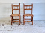 A Set of 8 Antique Spanish Folk Art Dining Chairs with Woven Seats