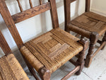 A Set of 8 Antique Spanish Folk Art Dining Chairs with Woven Seats