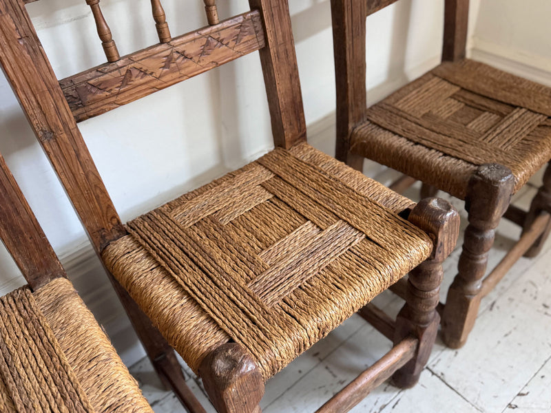 A Set of 8 Antique Spanish Folk Art Dining Chairs with Woven Seats