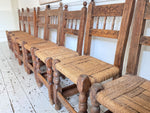 A Set of 8 Antique Spanish Folk Art Dining Chairs with Woven Seats