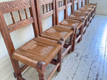 A Set of 8 Antique Spanish Folk Art Dining Chairs with Woven Seats