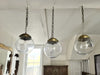 A Set of Three Czechoslovakian Glass Globe Pendant Lights