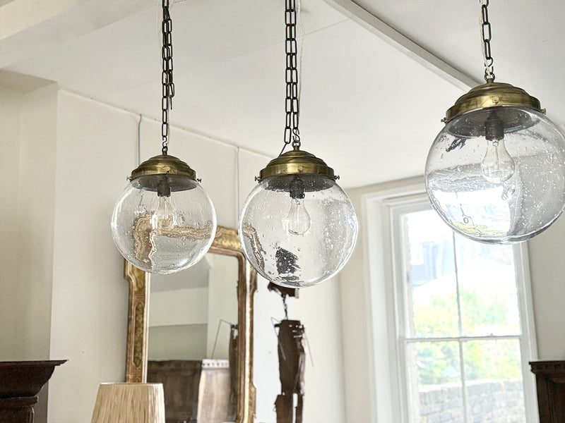 A Set of Three Czechoslovakian Glass Globe Pendant Lights