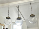 A Set of Three Czechoslovakian Glass Globe Pendant Lights