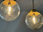 A Set of Three Czechoslovakian Glass Globe Pendant Lights