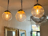 A Set of Three Czechoslovakian Glass Globe Pendant Lights