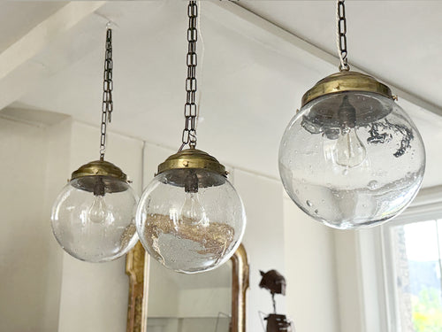 A Set of Three Czechoslovakian Glass Globe Pendant Lights