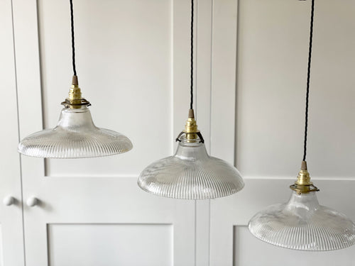 A Set of Three Antique Holophane Pendant Lights