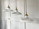 A Set of Three Antique Holophane Pendant Lights