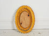 A 1950's French oval mirror with double layer of surrounding gold metal leaves