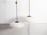 A Pair of Stilnovo Opaque Glass & Brass Pendant Lights