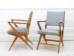Three 1950's cherry wood geometric vinyl covered armchairs