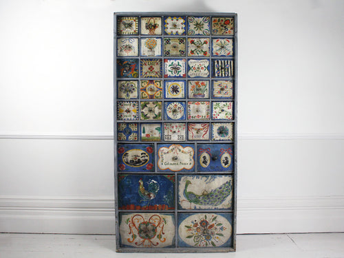 19th century haberdashery cupboard with hand painted drawers