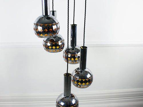 A 1960's 5 headed steel ceiling light with amber lining