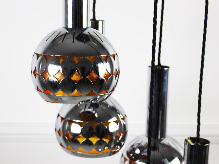 A 1960's 5 headed steel ceiling light with amber lining
