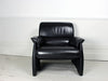 A pair of vintage black leather De Sede armchairs