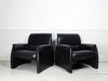 A pair of vintage black leather De Sede armchairs