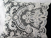 Ivory Edwardian lace on antique black linen bolster by Charlotte Casadéjus
