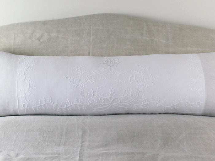 An antique linen bolster with embroidered pair of birds by Charlotte Casadéjus
