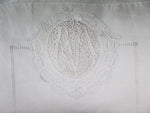 An intricate lace & threadwork monogrammed antique linen bolster by Charlotte Casadéjus
