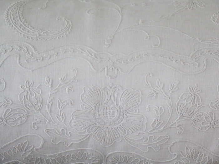 An antique linen bolster with Cornely embroidery centre panel by Charlotte Casadéjus