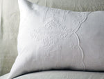 An antique linen bolster with scalopped Cornely embroidery by Charlotte Casadéjus