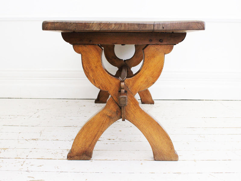 An Antique French Oak Cross Leg Sawbuck Trestle Dining Table